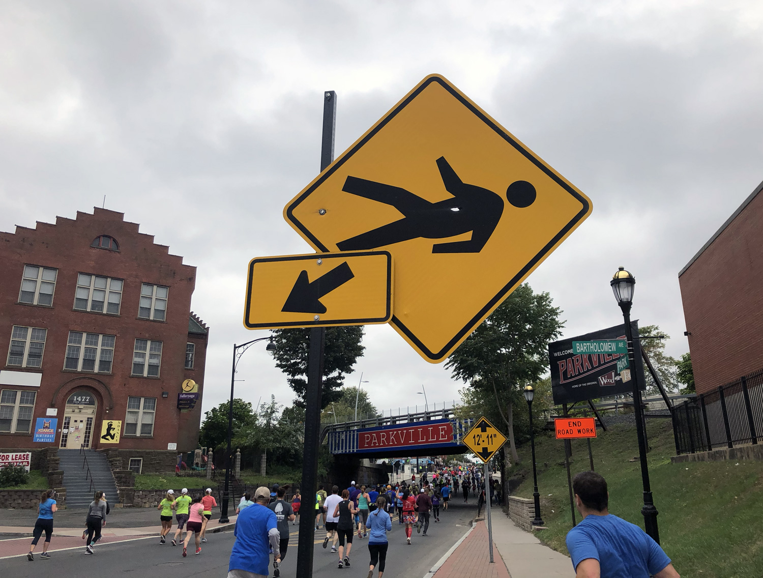 Sideways pedestrian sign looks perilous