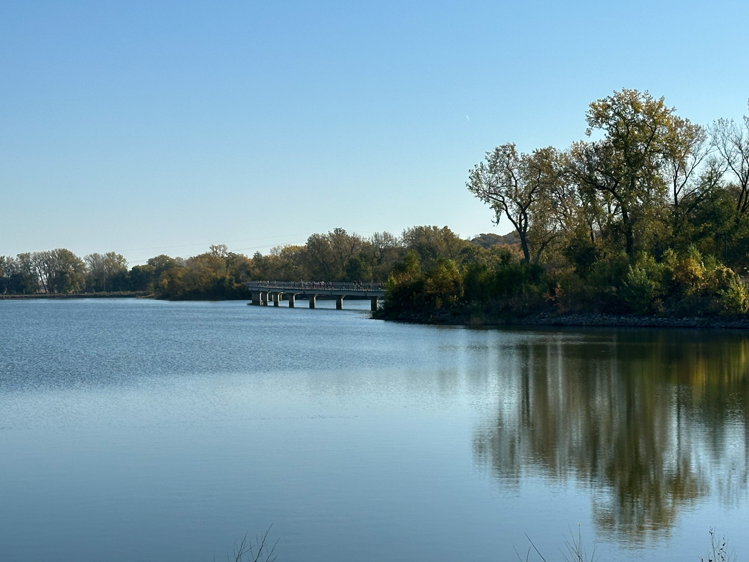 Runners on a distant bridge over Gray's Lake