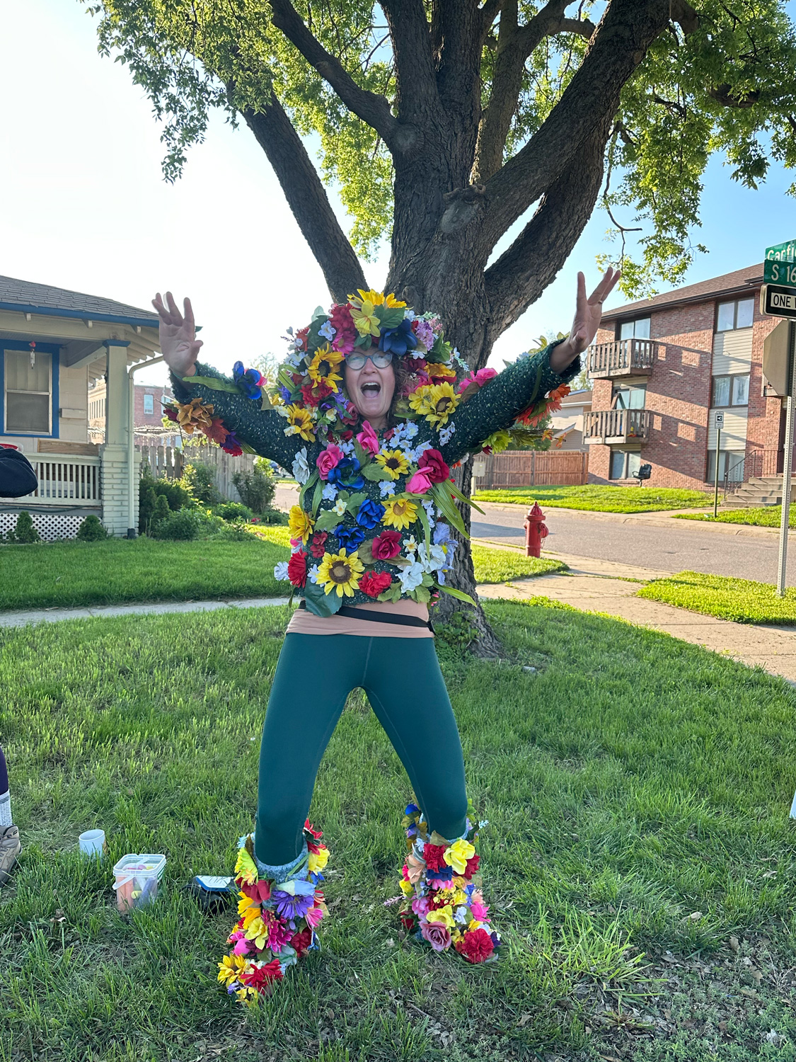 Woman dressed in flowers spectating at the race