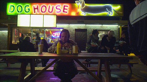 Doghouse stand in Albuquerque, lit up in neon at night